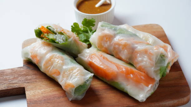 istock Vietnamese Spring Rolls Goi Cuon or Nem Cuon,  filled with prawns, herbs, rice vermicelli and vegetables. Served with hoisin and peanut sauce dip. 1411763728