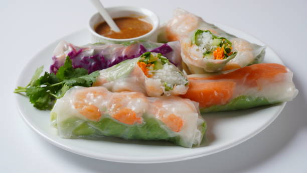 istock Vietnamese Spring Rolls Goi Cuon or Nem Cuon,  filled with prawns, herbs, rice vermicelli and vegetables. Served with hoisin and peanut sauce dip. 1411763730