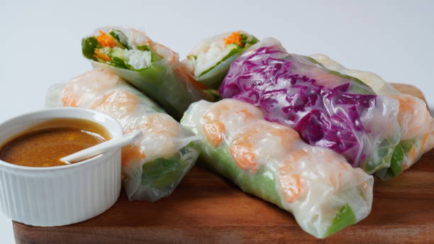 istock Vietnamese Spring Rolls Goi Cuon or Nem Cuon,  filled with prawns, herbs, rice vermicelli and vegetables. Served with hoisin and peanut sauce dip. 1411763747