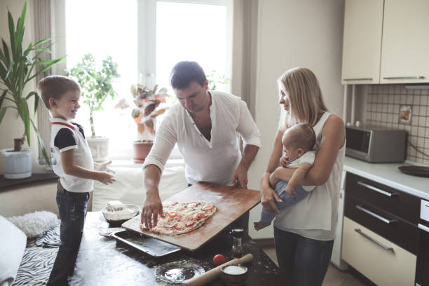 istock Traditional blond family in kitchen cook pizza 1411763957