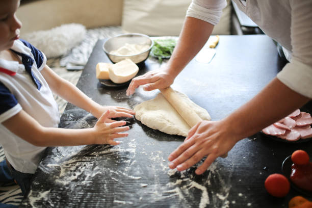 istock boy and dad  rolled dough in cozy interior 1411763975