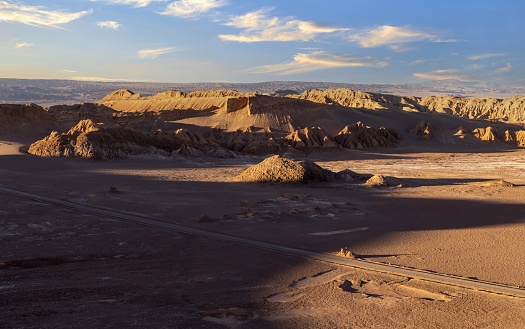San Pedro de Atacama, Chile, December 4, 2018: View of the Moon Valley at sunset time. The valley has various stone and sand formations which have been carved by wind and water. It has an impressive range of color and texture, looking somewhat similar to the surface of the moon.