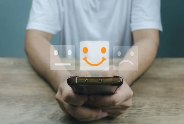istock Customer service and Satisfaction concept Men's hands doing online assessments in the satisfaction rating the popular service company allows customers in order to improve and develop the organization 1411766985