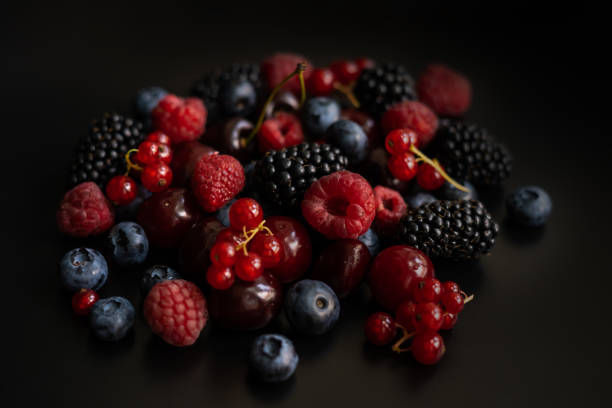 istock Berries are placed in a pile on a dark background 1411767029