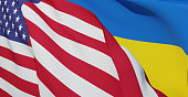 The U.S. flag and the flag of Ukraine are flying in the wind.