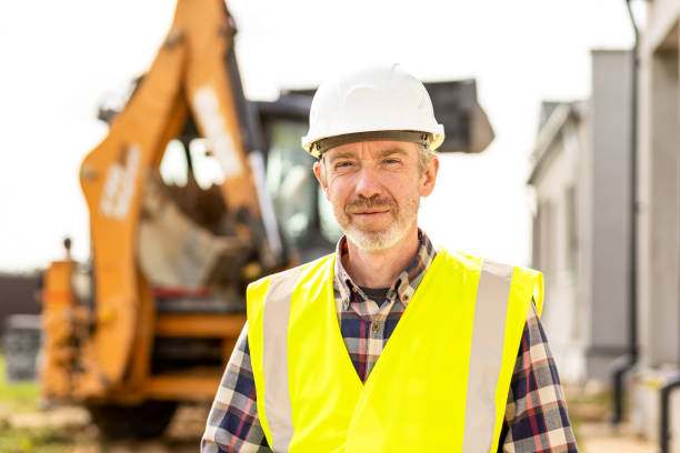 istock Mature men civil engineer supervises outdoor construction work 1411769376