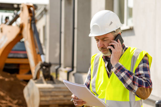 istock Mature men civil engineer supervises outdoor construction work 1411770305