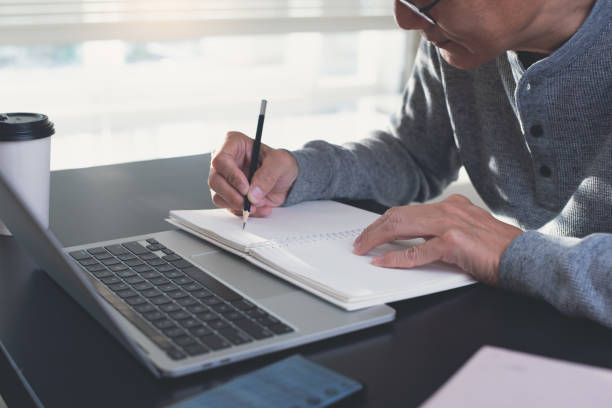 istock Asian casual business man working on laptop computer at home office 1411770651