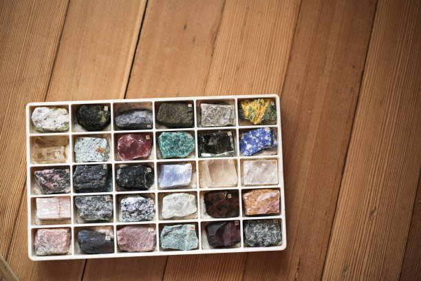Collection of minerals in box on wooden background Collection of minerals in a box on a wooden background, concept hobbies and collecting, research and science feldspar stock pictures, royalty-free photos & images