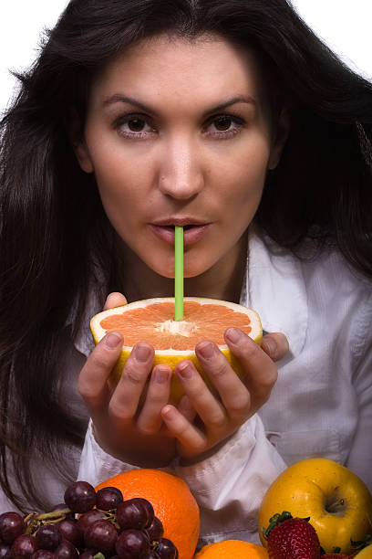 beautiful young woman with fruit stock photo