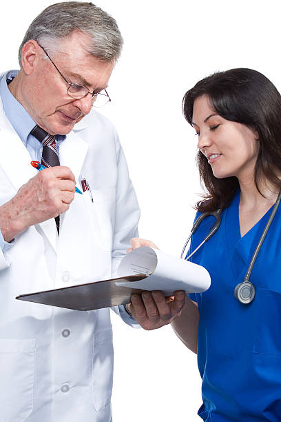 medical professionals discuss chart stock photo