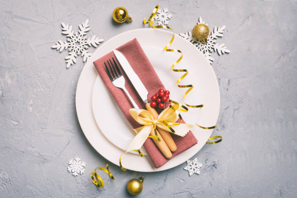 istock Christmas table place setting with christmas decor and plates, kine, fork and spoon. Christmas holiday background. Top view with copy space 1411776177