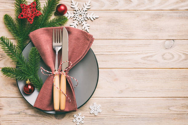 istock Christmas table place setting with christmas decor and plates, kine, fork and spoon. Christmas holiday background. Top view with copy space 1411776181
