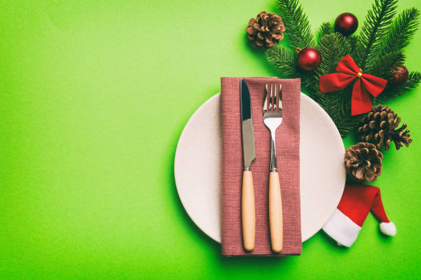 istock Christmas table place setting with christmas decor and plates, kine, fork and spoon. Christmas holiday background. Top view with copy space 1411776183