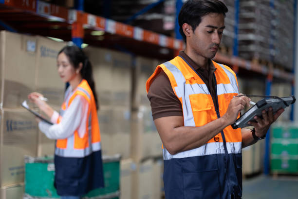 istock Warehouse worker and manager checks stock and inventory with digital tablet computer in the retail warehouse full of shelves with goods. Working in logistics, Distribution center. 1411776314