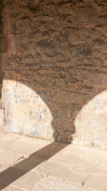 istock Arcade shadows in a stone cloister 1411776767