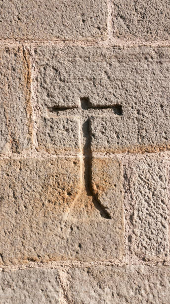 istock Cross sign carved in ancient wall 1411776848