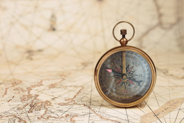istock Old vintage compass on ancient map background. Travel, geography, navigation concept. 1411779220