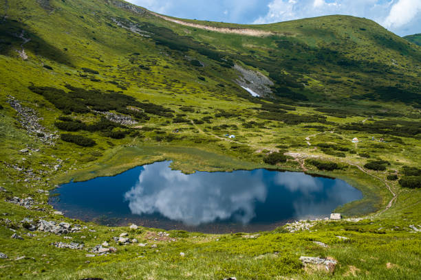istock Alpine lake in the mountains 1411781270