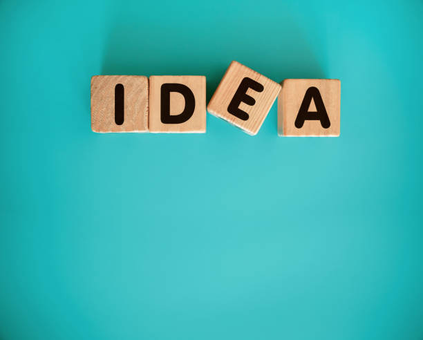 istock IDEA with wood block isolated on blue background 1411781872