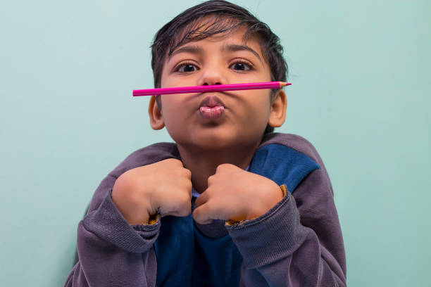 smiling young woman lying on the floor and drawing with colored markers