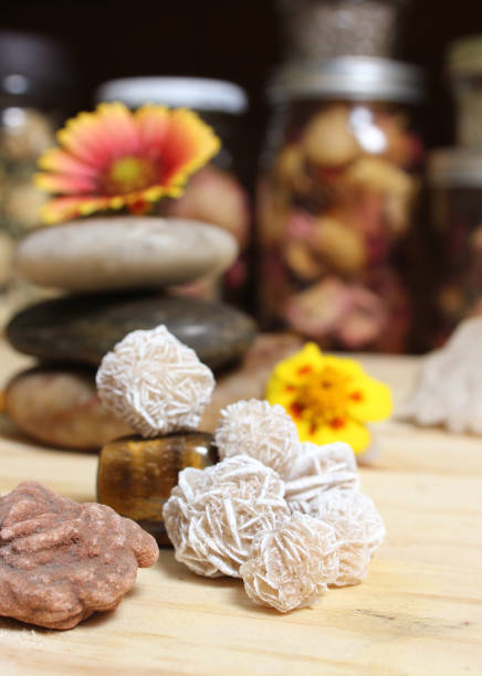istock Desert Rose Crystals and Balanced Stones With Flowers on Meditation Table 1411786164