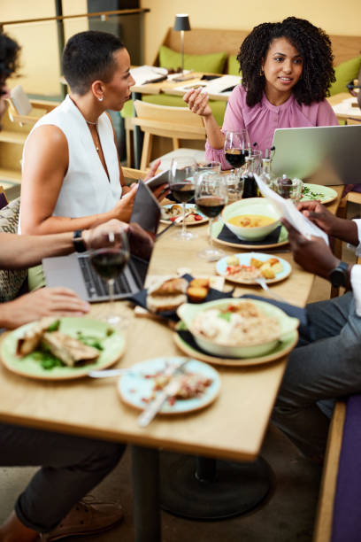 Multicultural colleagues brainstorm about a new project in a restaurant.