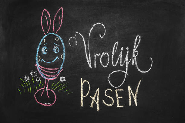 istock A beautiful Easter egg with bunnies and the inscription Happy Easter is drawn on a chalkboard 1411787656