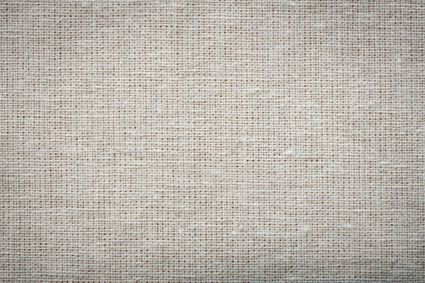 istock Burlap linen weave fabric background. Sackcloth material. Natural woven rustic bagging material. Light textile texture. Sacking linen fabric pattern. Closeup top view. 1411787845
