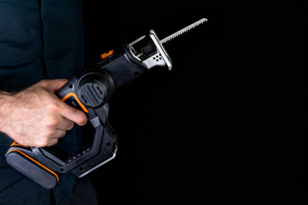 istock Cordless saw in hand on black background 1411787864