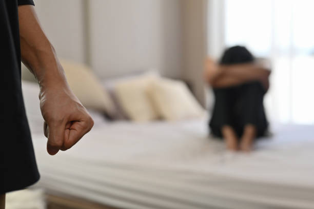 Selective focus on the fist male with crying man sits on a bed as the background, Violence, Love and relationships, Gay couple, sexual harassment concept. Selective focus on the fist male with crying man sits on a bed as the background, Violence, Love and relationships, Gay couple, sexual harassment concept. child abuse stock pictures, royalty-free photos & images