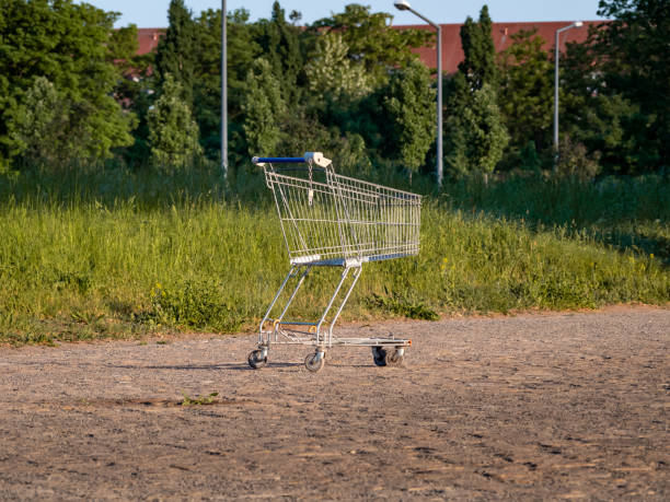 Overturned empty grocery shopping cart. Isolated on white background.