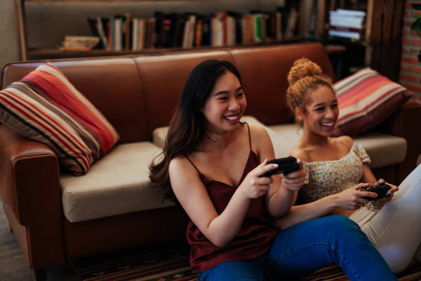 istock Lesbian couple playing video games together 1411794686
