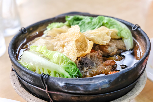 Close up of Bak kut teh,  pork ribs dish cooked in broth infused with herbs.