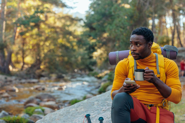 istock Young tourist resting in the mountain and text messaging 1411794980