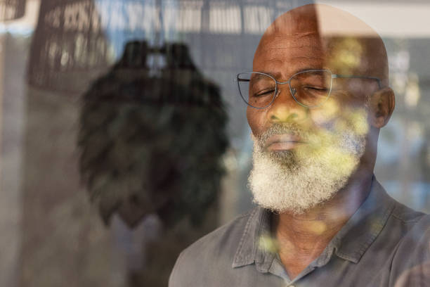 istock Senior man standing inside and taking a deep breath 1411795703