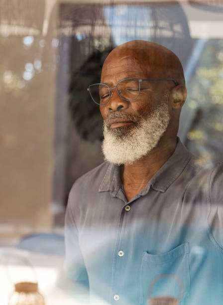 istock Senior man standing inside and taking a deep breath 1411795704