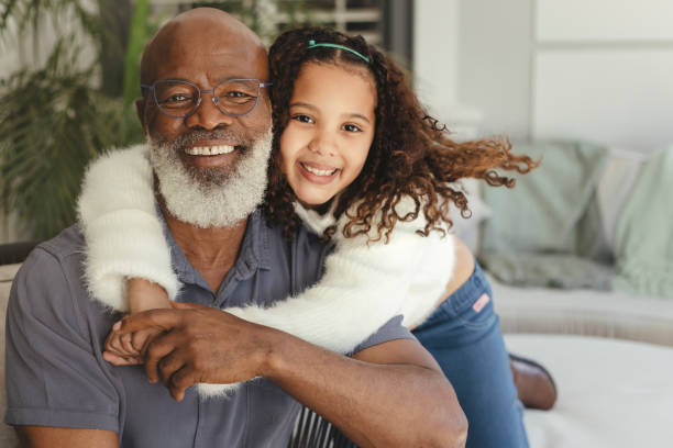 cute little girl hugging her grandfather - great grandchild imagens e fotografias de stock