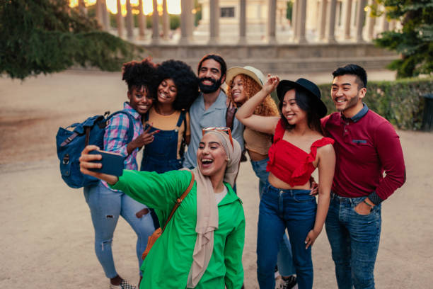 istock Group of tourists taking selfie 1411795784