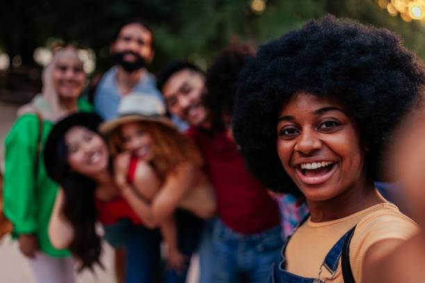 istock Friends taking group selfie outdoors POV 1411795793