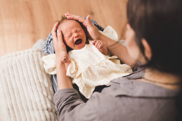 woman with sick crying baby on hands wake up - colic imagens e fotografias de stock