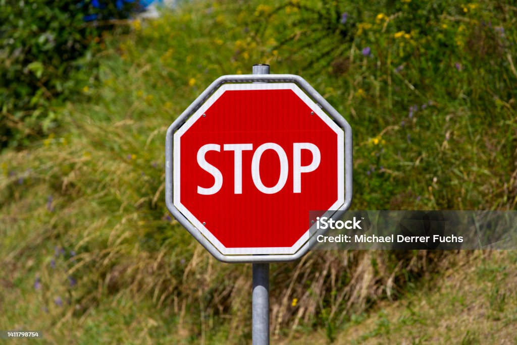 Close-up of red and whit stop road sign at village of Airolo, Canton Ticino, on a sunny summer day. Photo taken June 25th, 2022, Airolo, Switzerland. Airolo Stock Photo