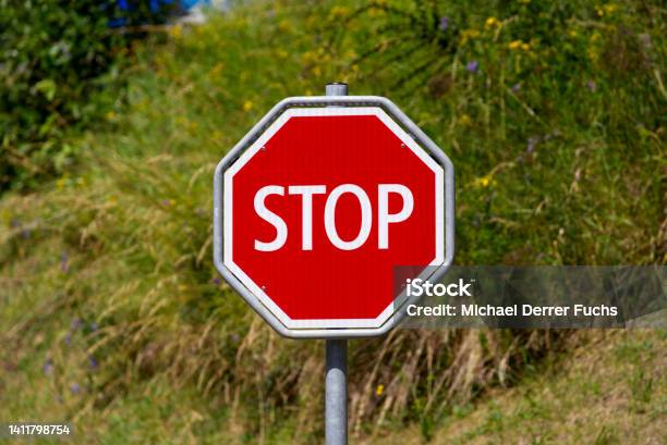 Closeup Of Red And Whit Stop Road Sign At Village Of Airolo Canton Ticino On A Sunny Summer Day Stock Photo - Download Image Now