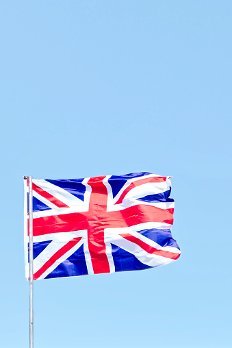 Union Jack flag suspended high in sky UK