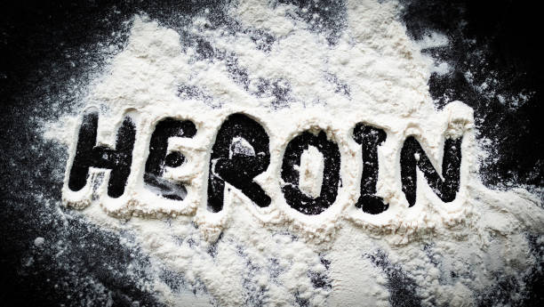 Heroin drug. powder heroin on dark black table background. stock photo