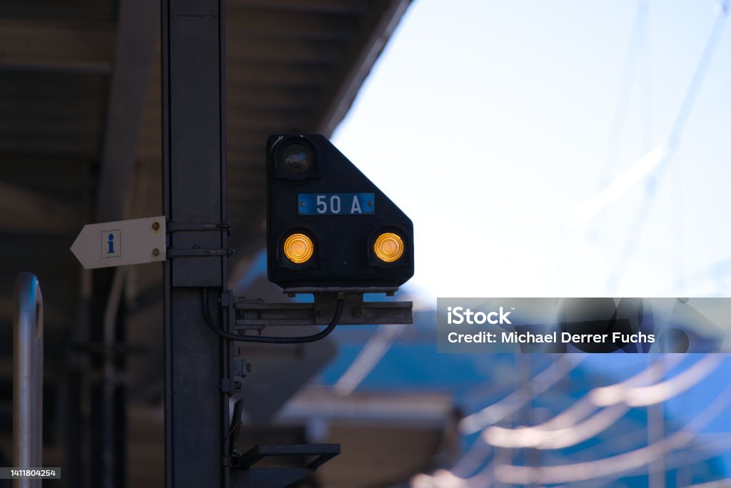 Close-up of railway signal at railway station Airolo, Canton Ticino, with railway tracks and platform on a sunny summer day. Photo taken June 25th, 2022, Airolo, Switzerland. Airolo Stock Photo