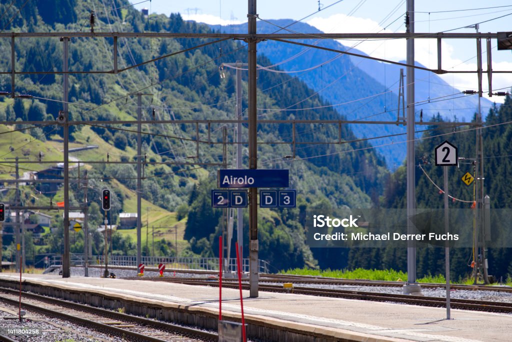 Railway station Airolo, Canton Ticino, with railway tracks and platform on a sunny summer day. Photo taken June 25th, 2022, Airolo, Switzerland. Airolo Stock Photo