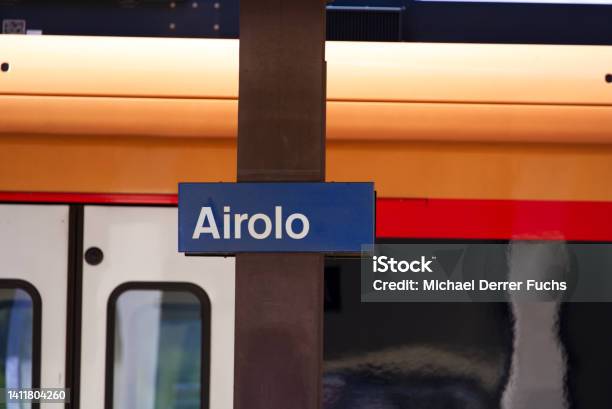 Closeup Of Blue Sign At Railway Station Airolo Canton Ticino On A Sunny Summer Day Stock Photo - Download Image Now