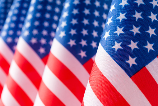 United States of America flags in a row, close up, selective focus
