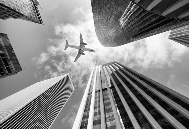 Airplane flying over skyscrapers, San Francisco, California, USA.